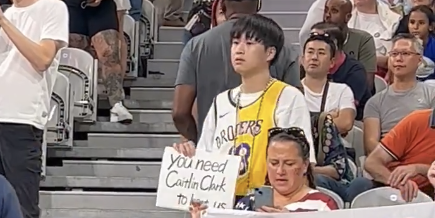 Fan holds Caitlin Clark sign at U.S. women's Olympic basketball game
